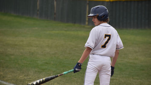 Baseball player reading to bat