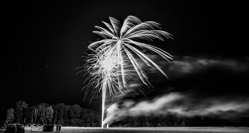 Low angle view of fireworks against sky at night