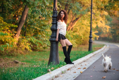 Woman standing by plants during autumn