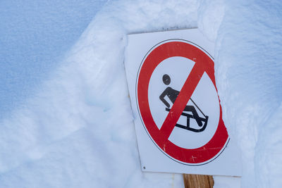 Close-up of warning sign on snow