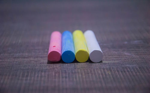 High angle view of colorful chalks on wooden table
