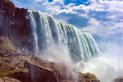 Panoramic view of waterfall against sky