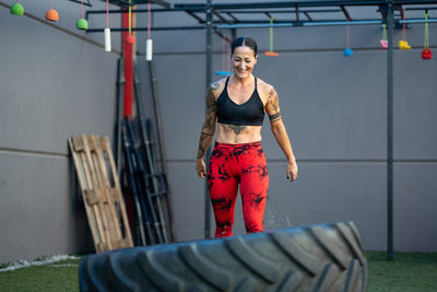 Portrait of young woman exercising in gym