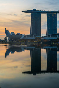 Reflection of marina bay sands and artscience museum at sunrise.