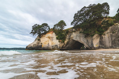 Scenic view of rocks in sea against sky