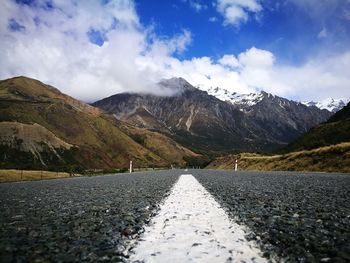 Road amidst mountains against sky