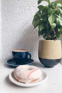 Coffee cup on table against wall