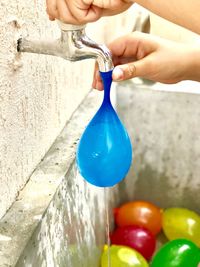 Close-up of hand filling balloon