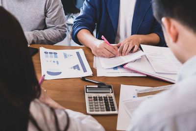 Midsection of man and woman using smart phone
