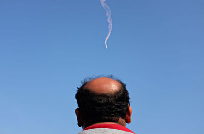 Man wearing mask against sky