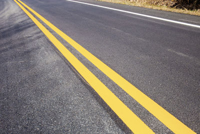 High angle view of yellow road marking on street