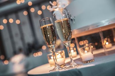 Close-up of champagne flutes on table at restaurant