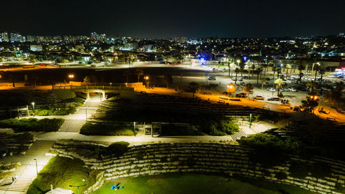 High angle view of illuminated buildings in city at night