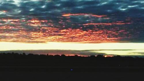 Scenic view of landscape against cloudy sky