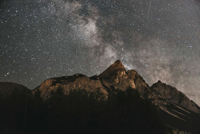 Scenic view of mountains against star field at night