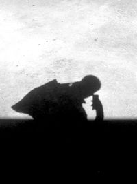 Silhouette of man shadow on hand