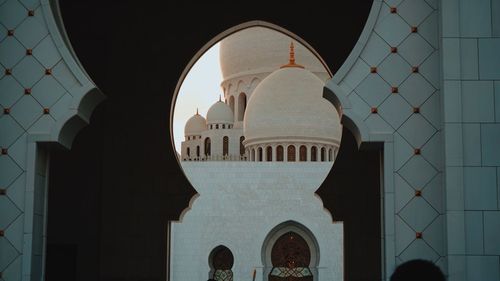 Historic mosque seen through arch during sunset