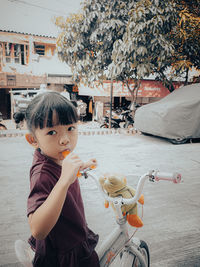 Close-up of boy blowing bubbles while sitting on bed at home