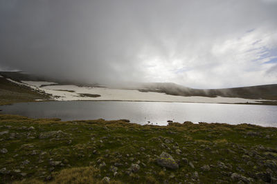 Alpine mountain lake landscape and view, snow and clouds in javakheti, georgia