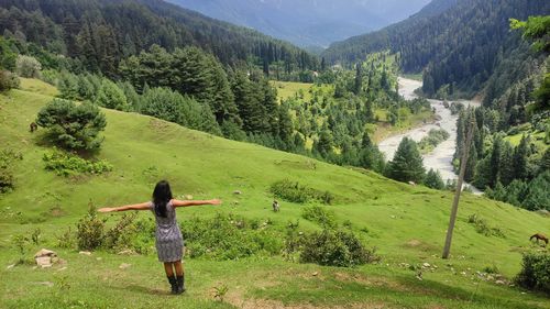 Full length of woman standing on mountain