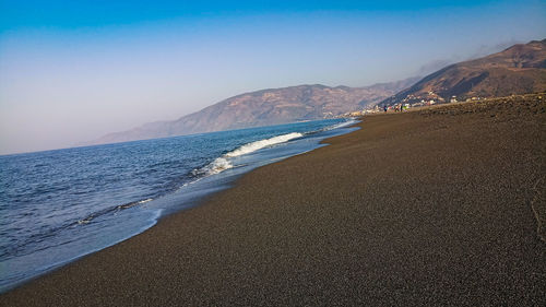 Scenic view of beach against clear sky