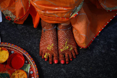 High angle view of beautiful bride legs with henna tattoo 