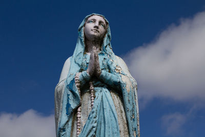 Low angle view of statue against sky