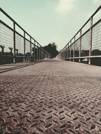 Surface level of empty road against sky