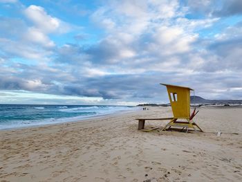 Lifeguard hut on beach against sky