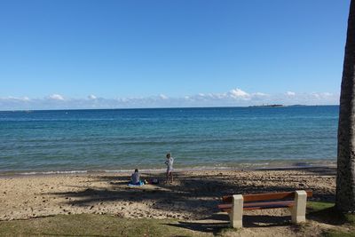 Scenic view of beach against blue sky