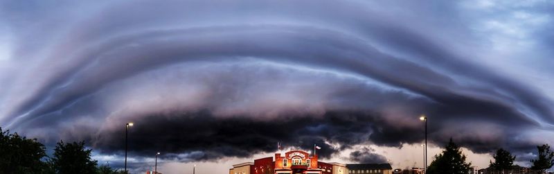 Low angle view of lightning in city against sky