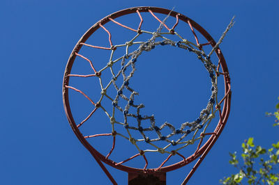 Low angle view of basketball hoop against blue sky