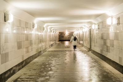 Man walking in illuminated subway station