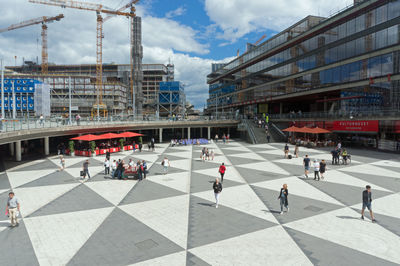 Group of people walking in front of buildings