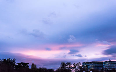 Low angle view of tree against cloudy sky