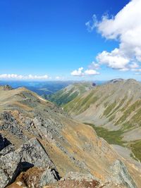 Scenic view of mountains against blue sky