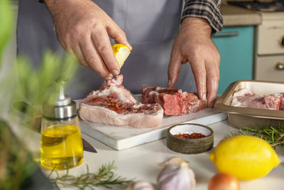 Midsection of man preparing food on table