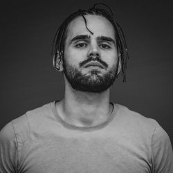 Portrait of young man against black background