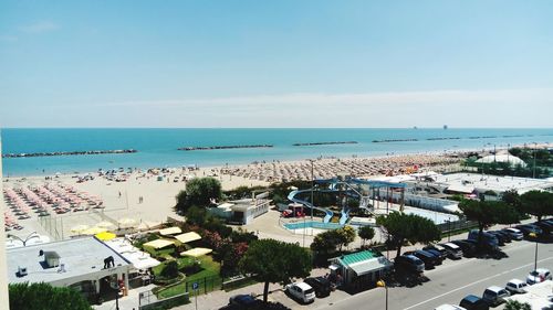 High angle view of town by sea against clear sky