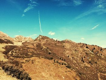 Low angle view of mountain against blue sky