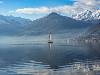 Scenic view of lake and snowcapped mountains against sky