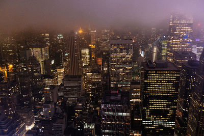 High angle view of city lit up at night