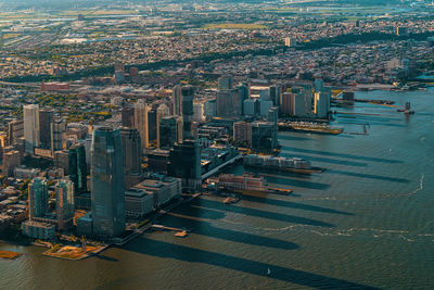 High angle view of river against modern buildings in city