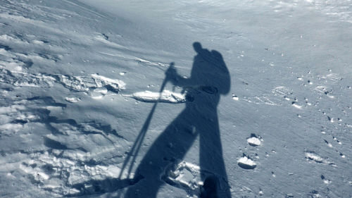 High angle view of people skiing on snowcapped land