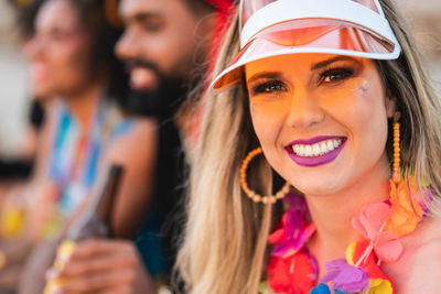 Portrait of smiling woman wearing cap chilling with friend