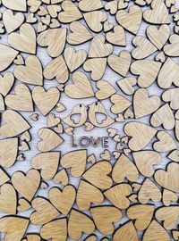 Full frame shot of wooden heart shapes with love text