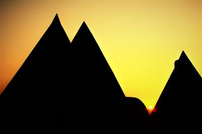 Silhouette of building against sky during sunset