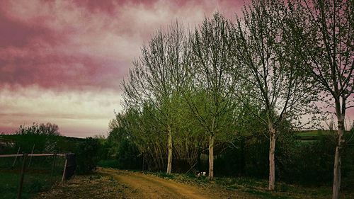 Empty road against cloudy sky