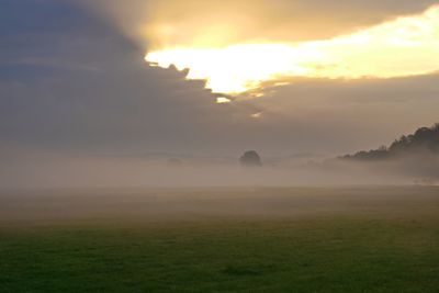 Scenic view of field against sky during sunset