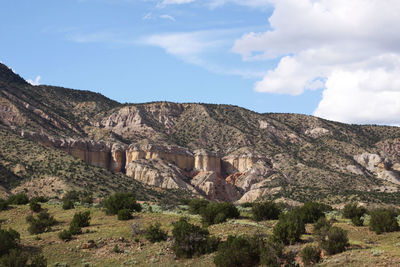 Scenic view of rocky mountains against cloudy sky